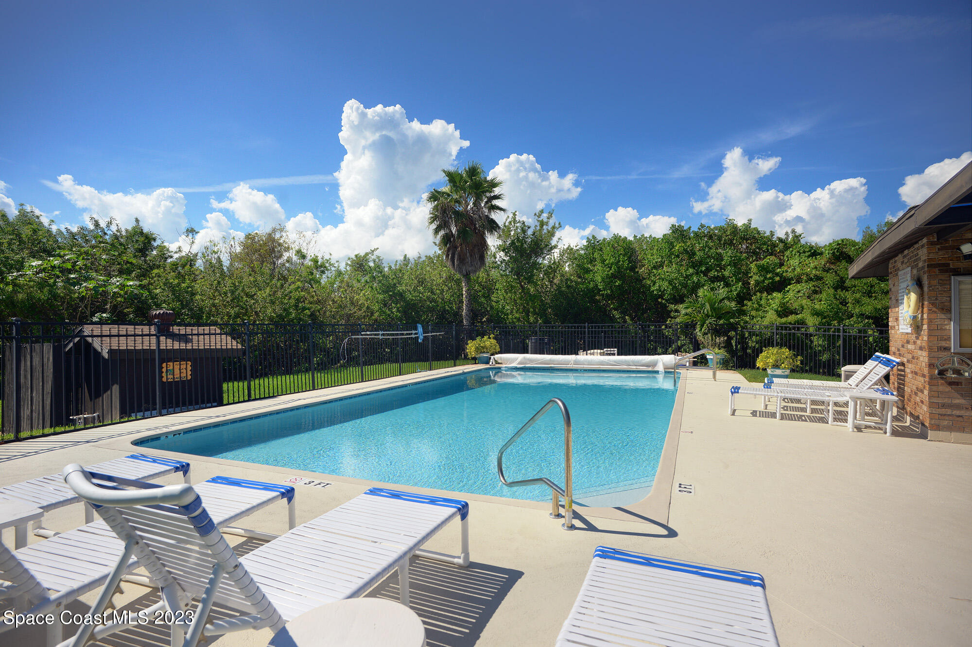 116 Normandy Place Melbourne Beach, FL 32951 - Photo 21 of 24 a view of a swimming pool with a lounge chairs