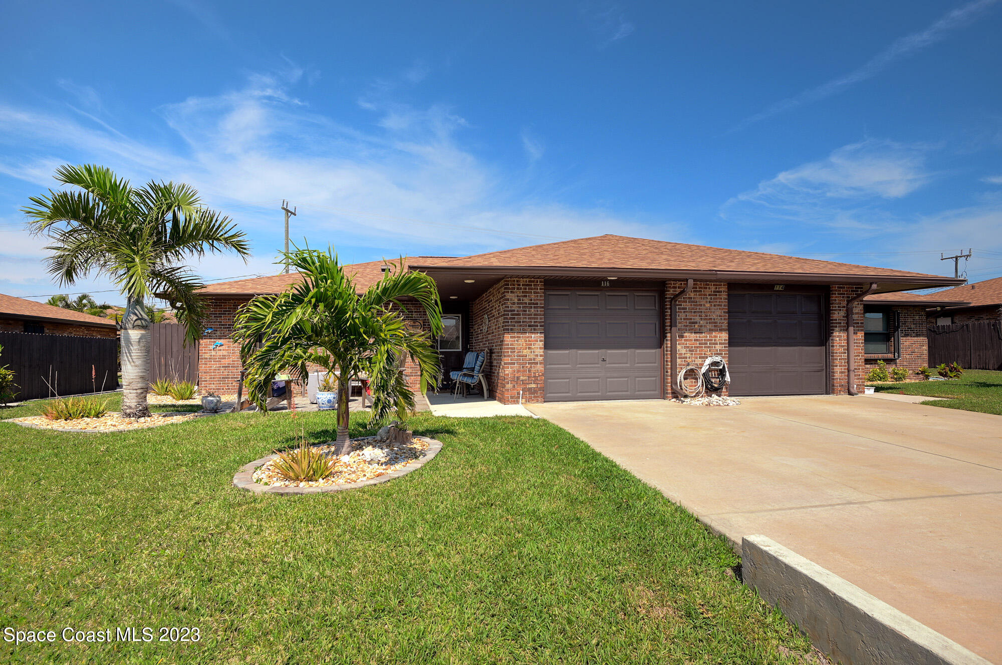 116 Normandy Place Melbourne Beach, FL 32951 - Photo 4 of 24 a view of a house with swimming pool and a garden