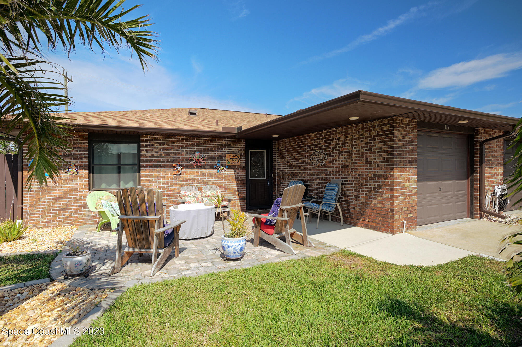 116 Normandy Place Melbourne Beach, FL 32951 - Photo 5 of 24 a view of a chairs and table in patio with a barbeque