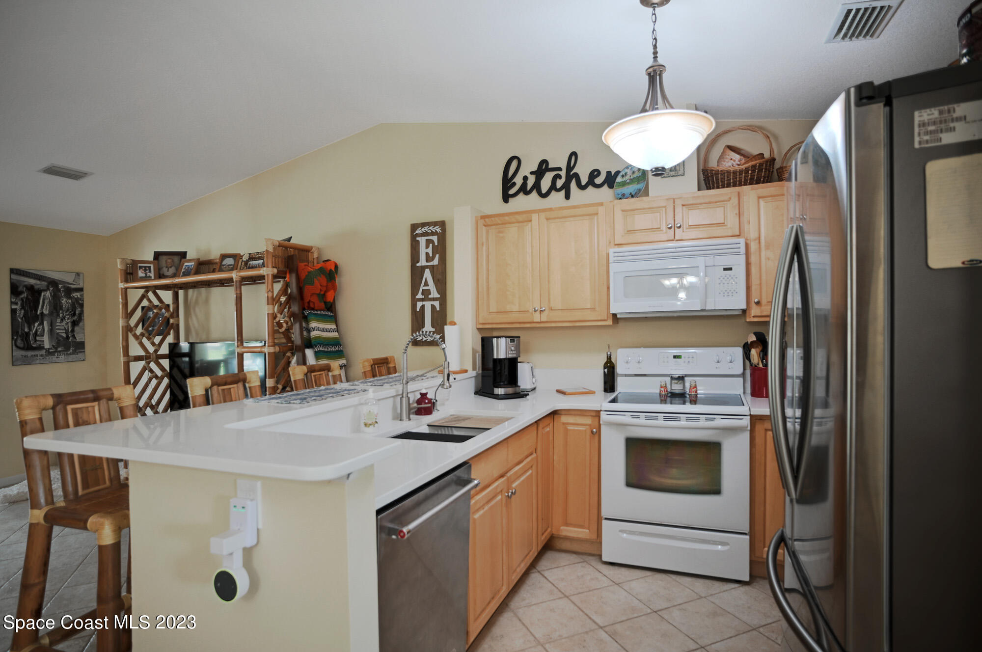 116 Normandy Place Melbourne Beach, FL 32951 - Photo 8 of 24 a kitchen with a sink stove and refrigerator