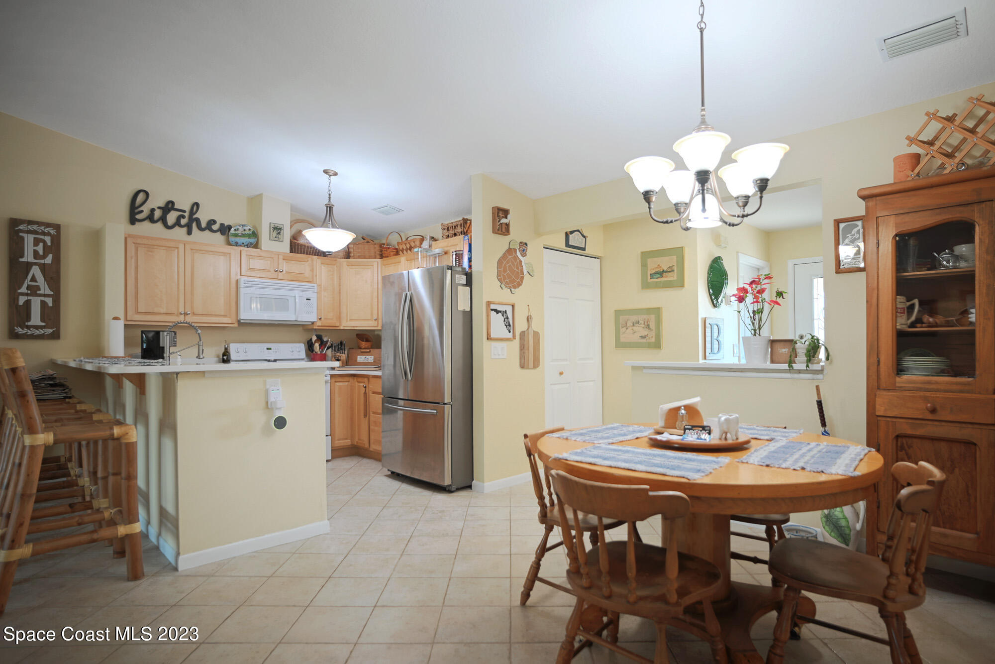 116 Normandy Place Melbourne Beach, FL 32951 - Photo 9 of 24 a view of kitchen with refrigerator table and chairs