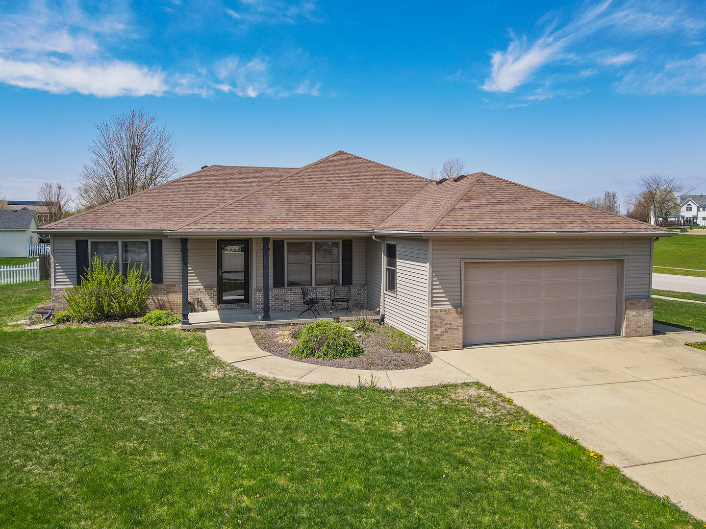 a front view of a house with a garden and porch