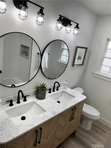 a living room with furniture potted plant and a chandelier