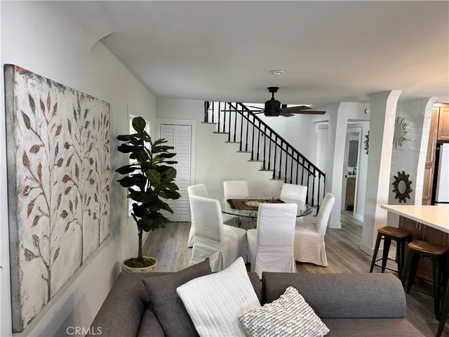 a kitchen with a dining table chairs and white cabinets