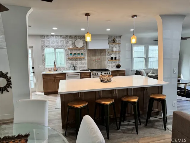 a living room with stainless steel appliances kitchen island granite countertop furniture and a kitchen view