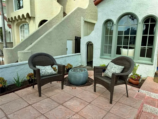 a front view of a house with outdoor seating and a potted plant