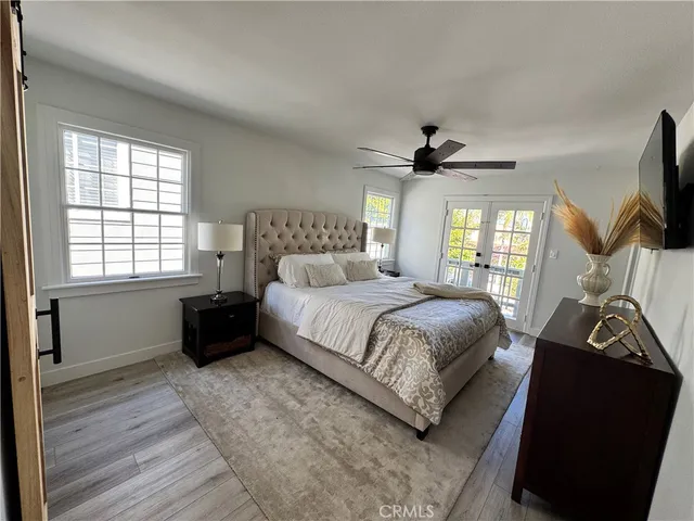 a bedroom with a bed and a flat tv screen on the dresser