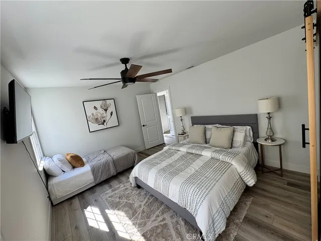 a bedroom with bed and a flat screen tv
