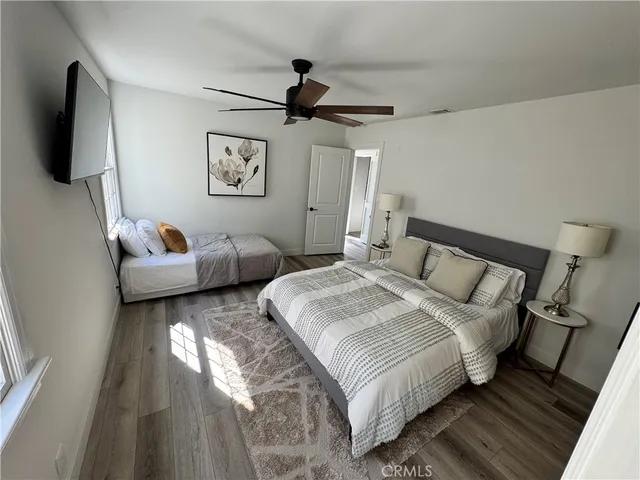 a bedroom with bed and a flat screen tv