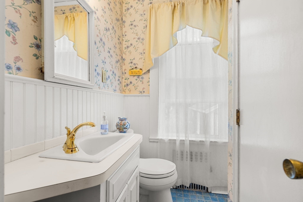 15 Beacon Street Danvers, MA 01923 - Photo 12 of 42 a bathroom with a sink a toilet and a window