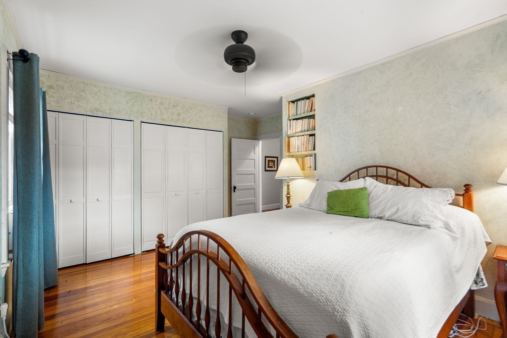 15 Beacon Street Danvers, MA 01923 - Photo 18 of 42 a bedroom with a bed and a chandelier