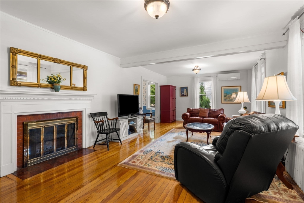 15 Beacon Street Danvers, MA 01923 - Photo 2 of 42 a living room with furniture a fireplace and a flat screen tv