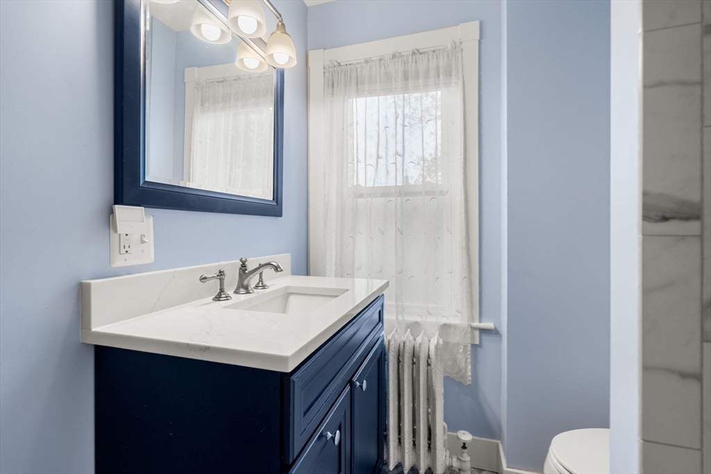 15 Beacon Street Danvers, MA 01923 - Photo 22 of 42 a bathroom with a sink vanity mirror and toilet