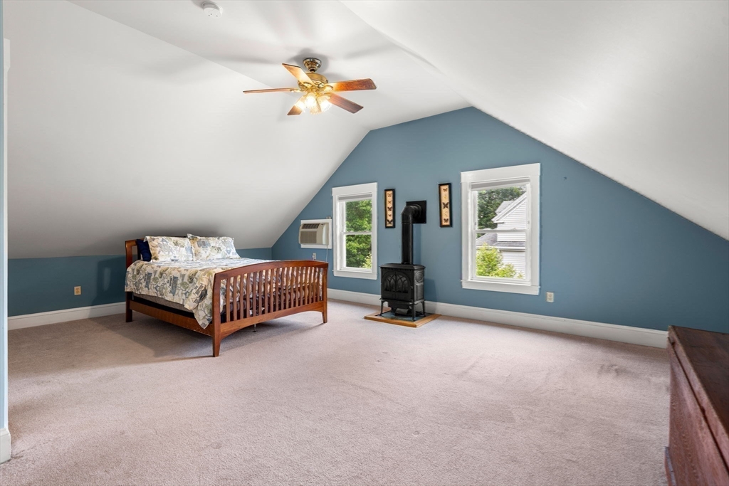 15 Beacon Street Danvers, MA 01923 - Photo 23 of 42 a bedroom with a bed and a chandelier