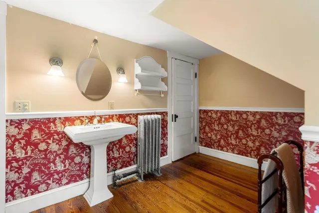 a view of a room with wooden floor and window