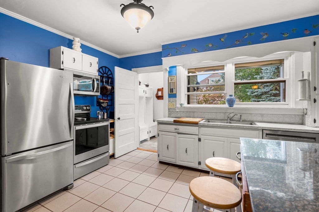 15 Beacon Street Danvers, MA 01923 - Photo 7 of 42 a kitchen with granite countertop a sink stainless steel appliances and window