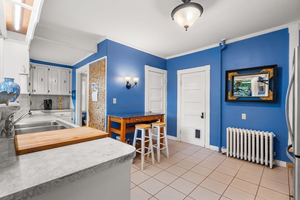 15 Beacon Street Danvers, MA 01923 - Photo 8 of 42 a spacious bedroom with a bed and a table in it