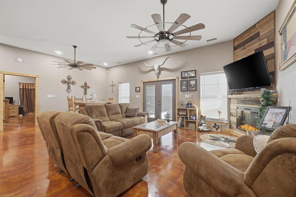 6499 Summerhill Road Abilene, TX 79601 - Photo 11 of 36 a living room with furniture a flat screen tv and a fireplace