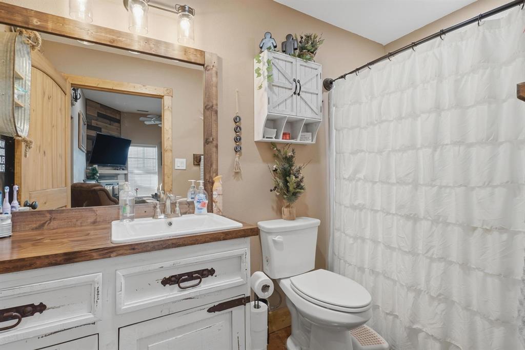 6499 Summerhill Road Abilene, TX 79601 - Photo 14 of 36 a bathroom with a sink a toilet and shower