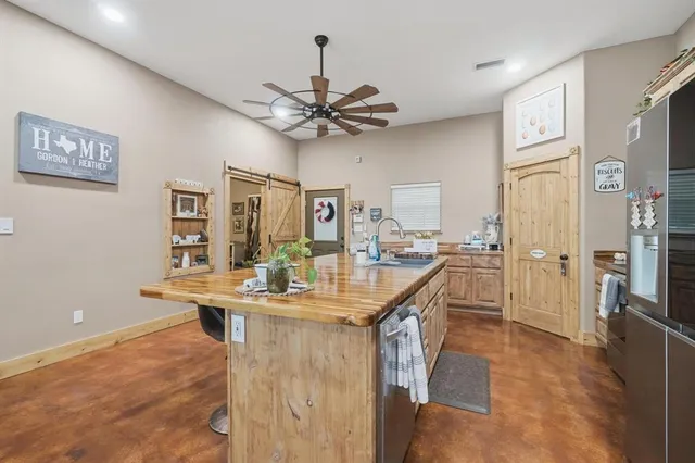 a living room with furniture a chandelier and a flat screen tv