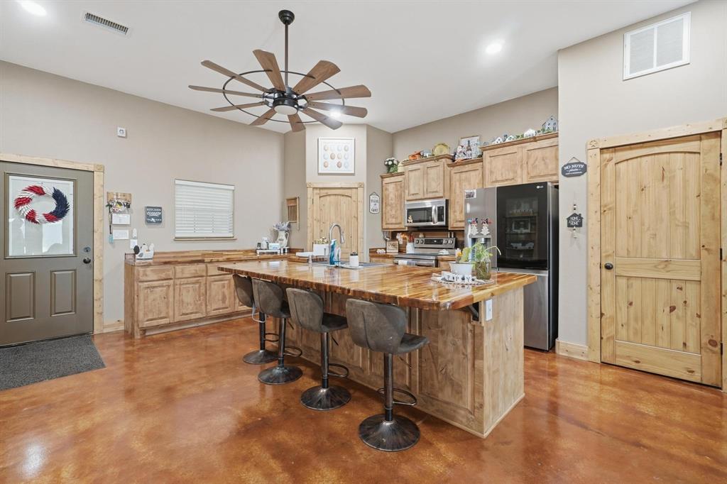 6499 Summerhill Road Abilene, TX 79601 - Photo 19 of 36 a kitchen with stainless steel appliances a sink stove and refrigerator