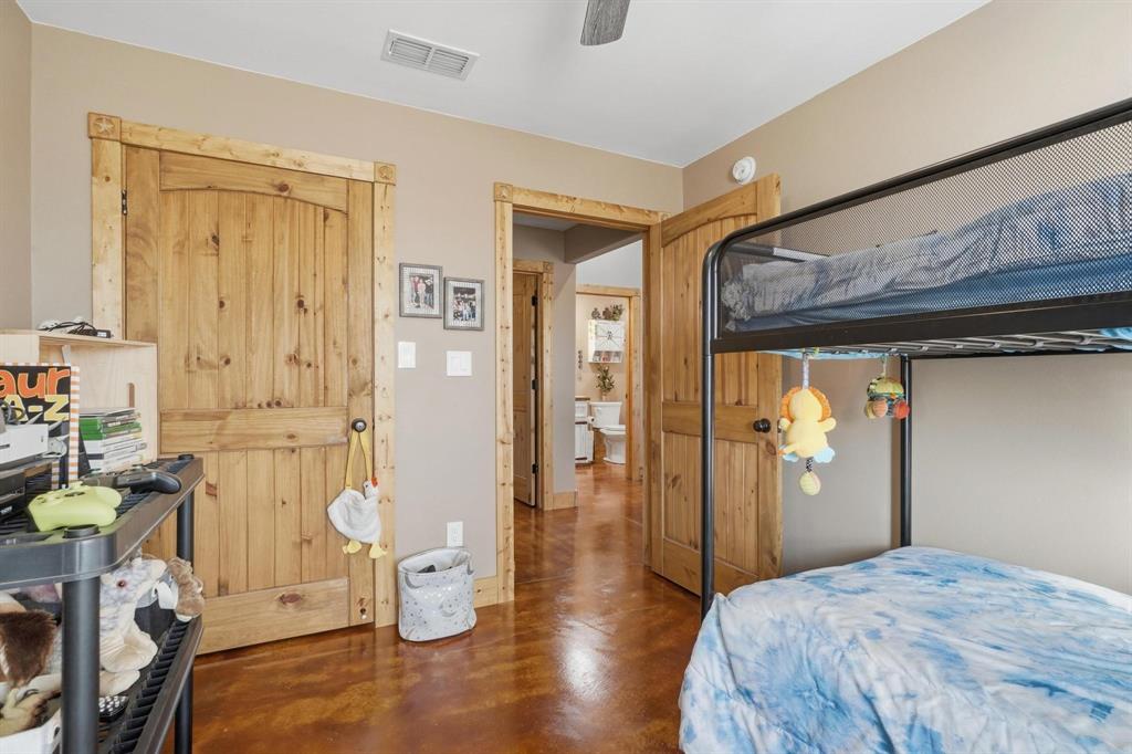 6499 Summerhill Road Abilene, TX 79601 - Photo 20 of 36 a bedroom with a bed and wooden floor