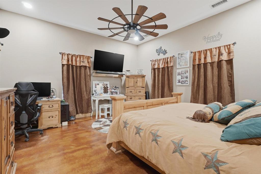 6499 Summerhill Road Abilene, TX 79601 - Photo 23 of 36 a bedroom with a bed and a flat screen tv