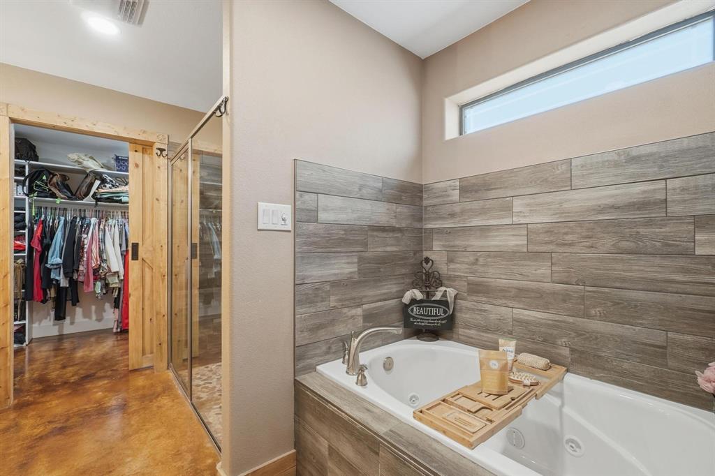 6499 Summerhill Road Abilene, TX 79601 - Photo 26 of 36 a bathroom with a tub and a sink