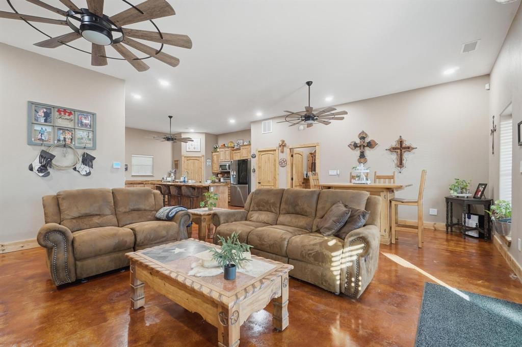 6499 Summerhill Road Abilene, TX 79601 - Photo 10 of 36 a living room with furniture kitchen view and a chandelier