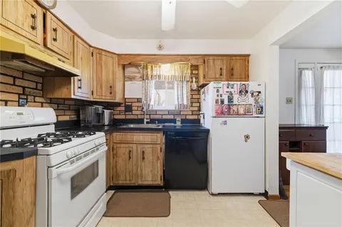 a kitchen with stainless steel appliances granite countertop a stove and a refrigerator