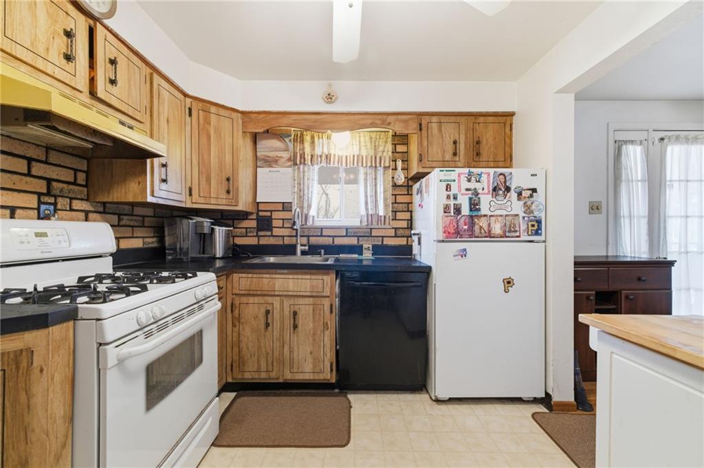 117 Overbrook Boulevard Pittsburgh, PA 15210 - Photo 11 of 30 a kitchen with stainless steel appliances granite countertop a stove and a refrigerator