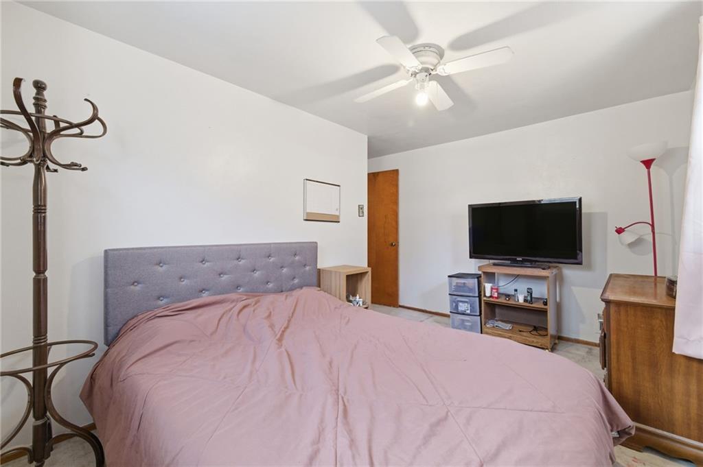 117 Overbrook Boulevard Pittsburgh, PA 15210 - Photo 13 of 30 a bedroom with a bed and a flat screen tv