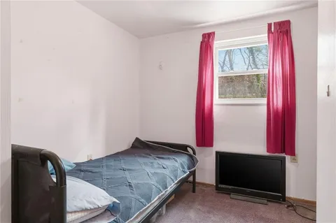 a bedroom with a bed and a mirror