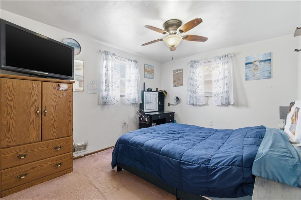 117 Overbrook Boulevard Pittsburgh, PA 15210 - Photo 16 of 30 a spacious bedroom with a bed and a flat screen tv