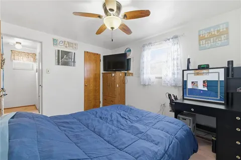 a bedroom with a bed dresser and a window