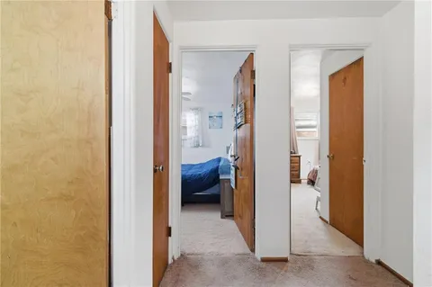 a view of a hallway with a livingroom and a livingroom