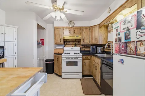 a kitchen with stainless steel appliances granite countertop a stove and a refrigerator