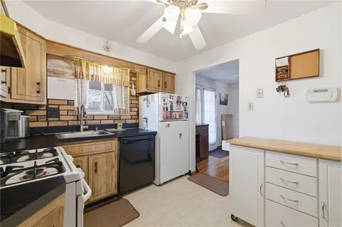 a kitchen with a sink stove and refrigerator