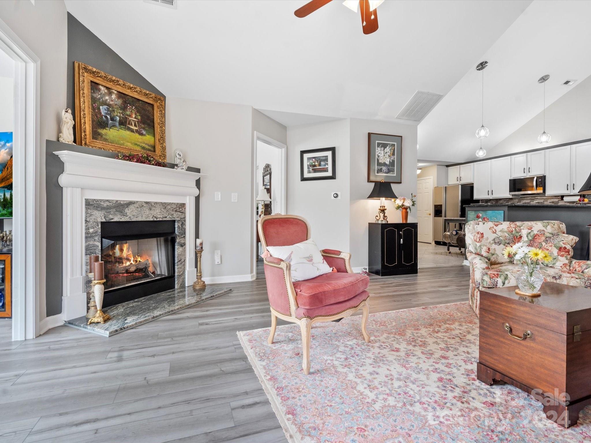 707 Ledgestone Court Fort Mill, SC 29708 - Photo 15 of 40 a living room with furniture a fireplace and a table