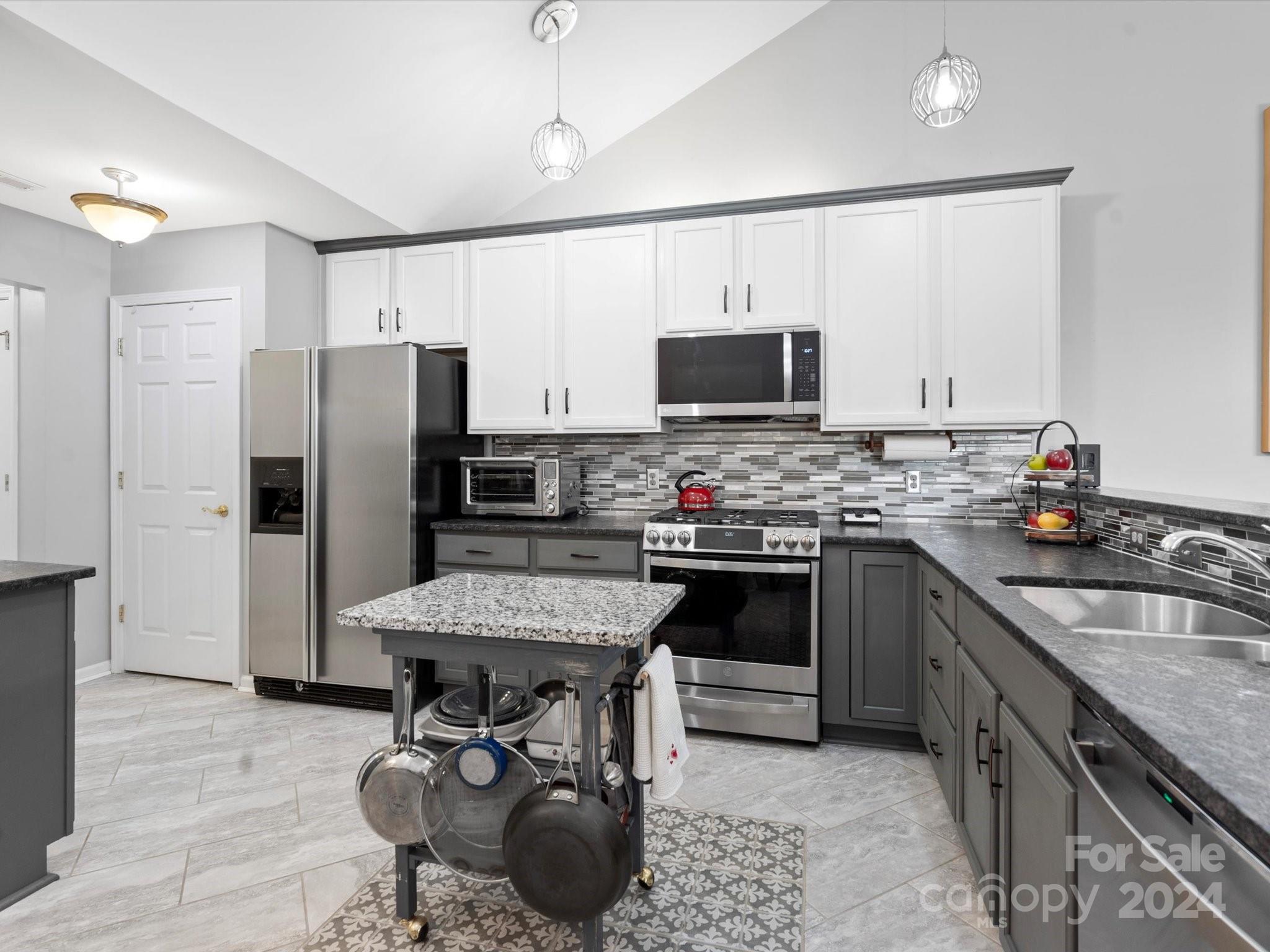 707 Ledgestone Court Fort Mill, SC 29708 - Photo 5 of 40 a kitchen with stainless steel appliances granite countertop a stove refrigerator sink and microwave