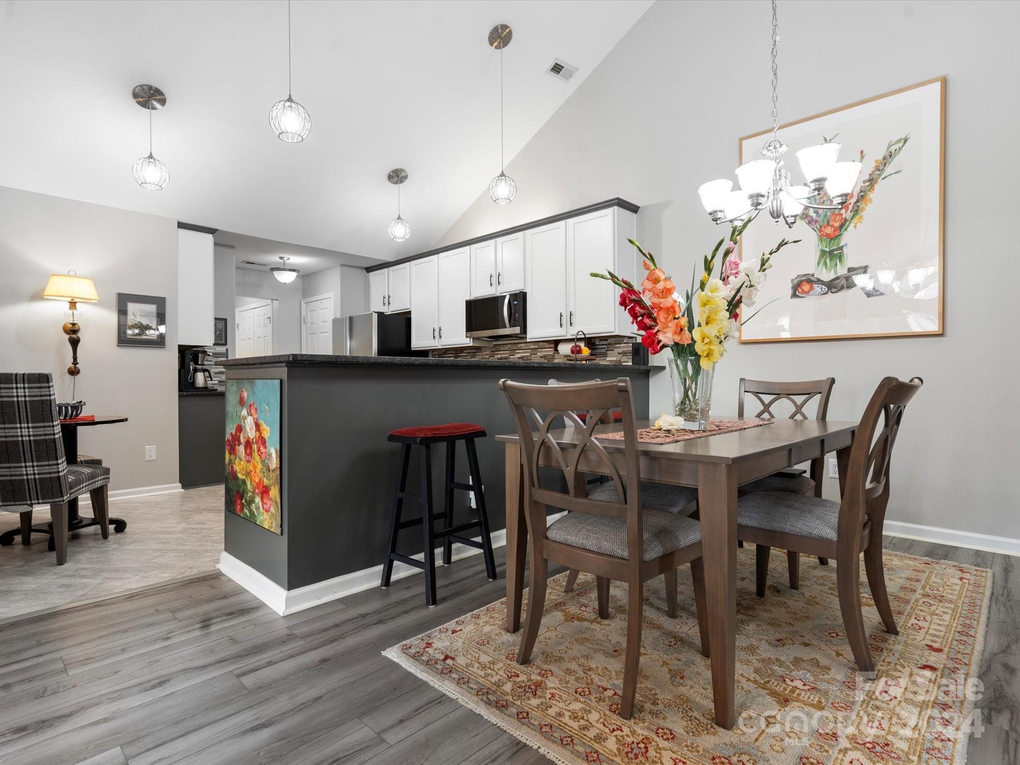 707 Ledgestone Court Fort Mill, SC 29708 - Photo 8 of 40 a view of a dining room with furniture and wooden floor