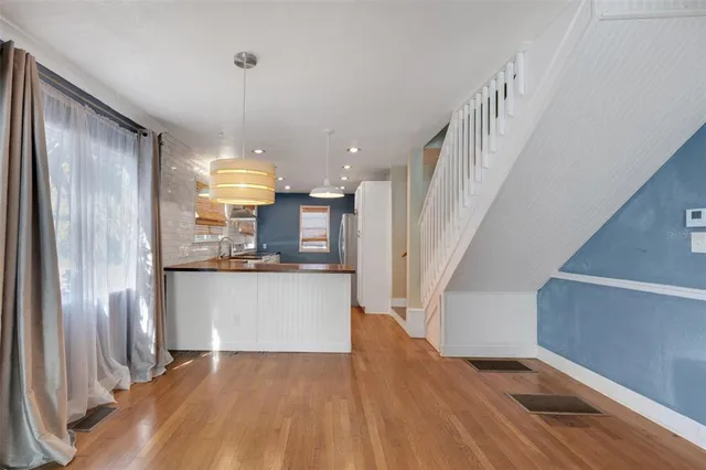 a kitchen with granite countertop a sink stainless steel appliances and cabinets