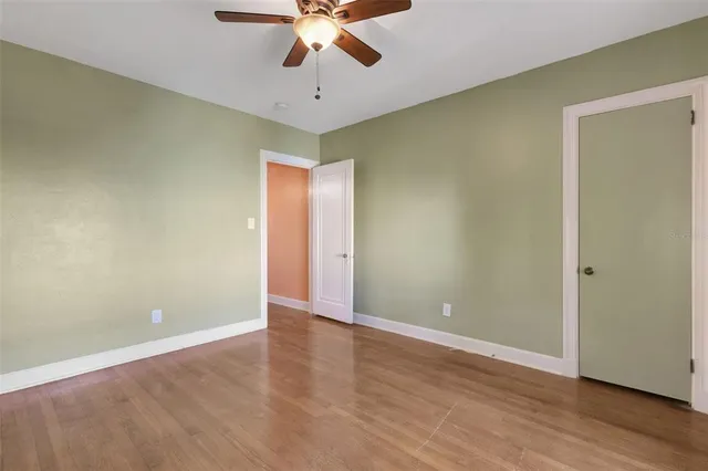 a view of a balcony with wooden floor and fence