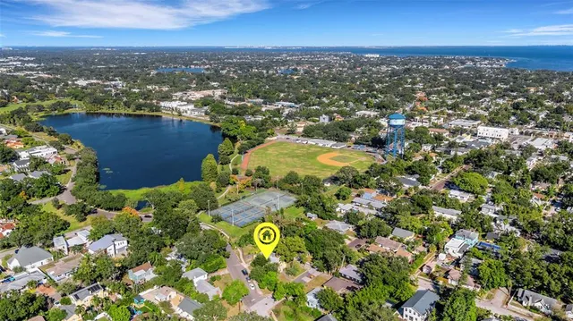 an aerial view of residential house with outdoor space and trees