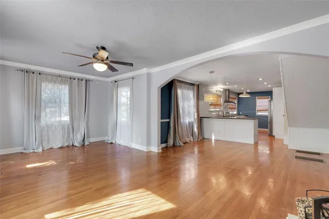 a view of a livingroom with wooden floor and furniture