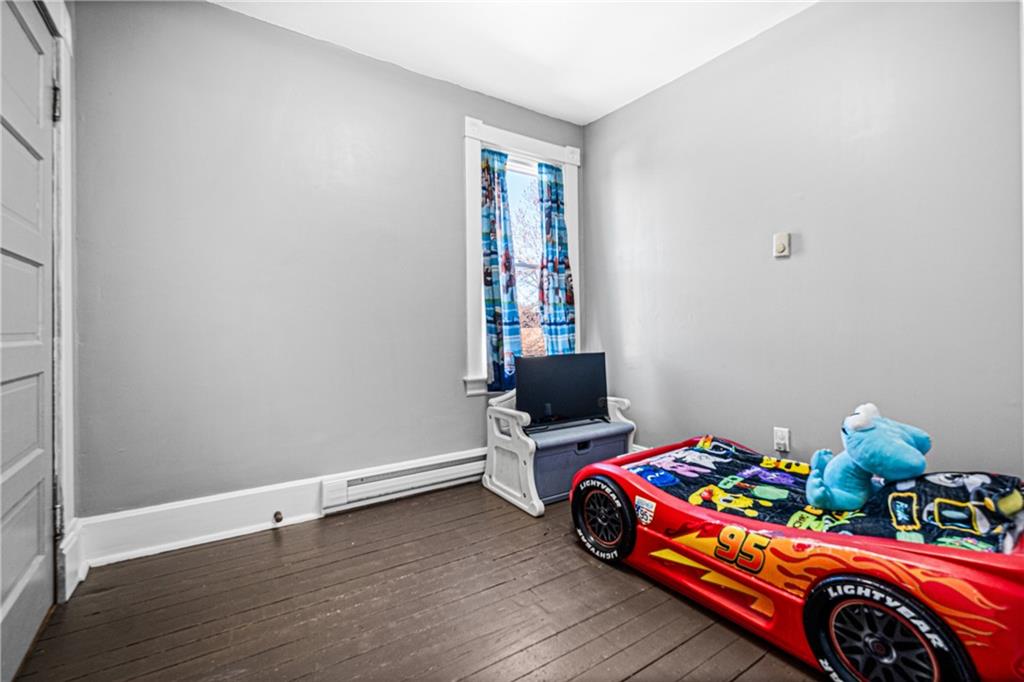 6 West Market Street Burgettstown, PA 15021 - Photo 20 of 24 a bedroom with a bed and wooden floor