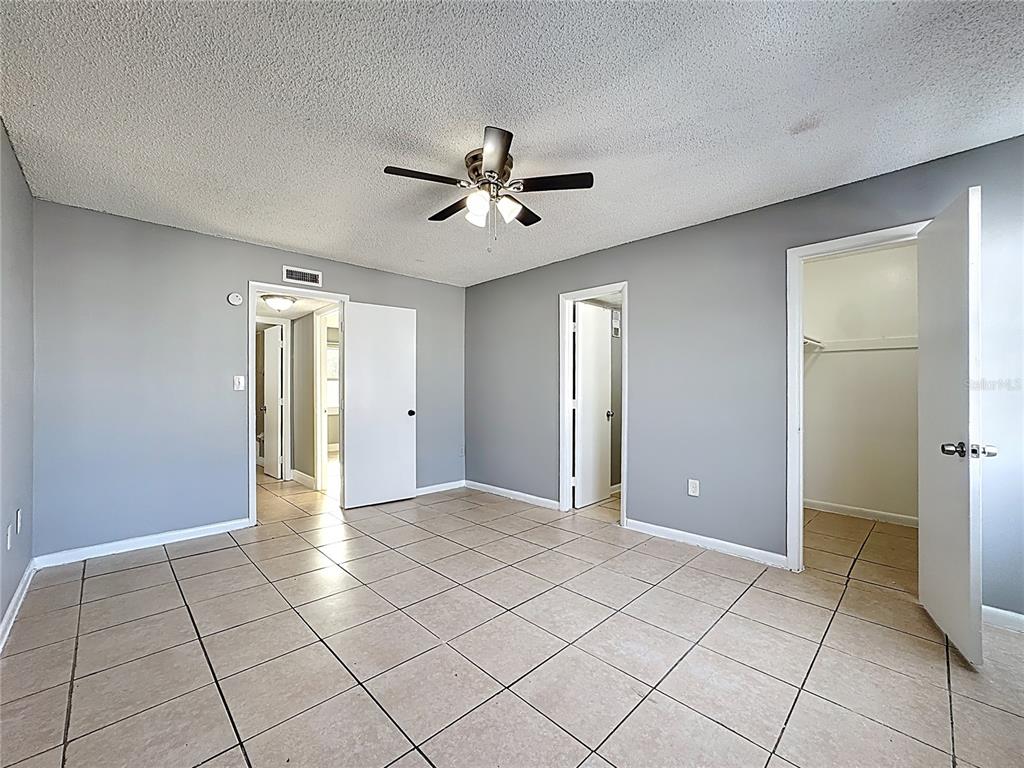 2753 L B McLeod Road, Unit D Orlando, FL 32805 - Photo 25 of 48 a view of an empty room with window and chandelier fan