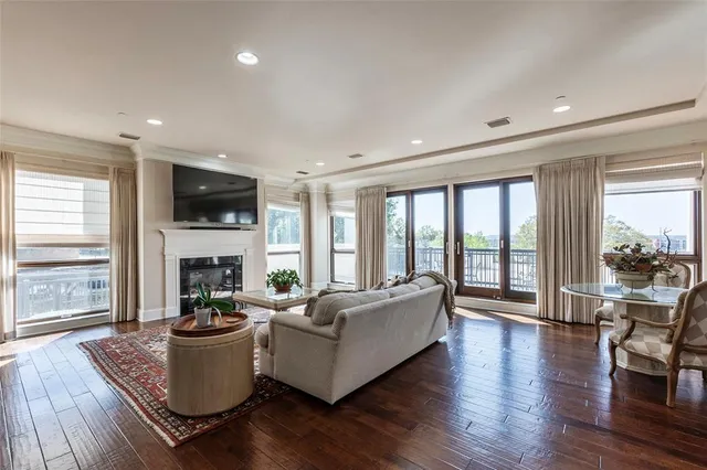 a living room with fireplace furniture and a large window
