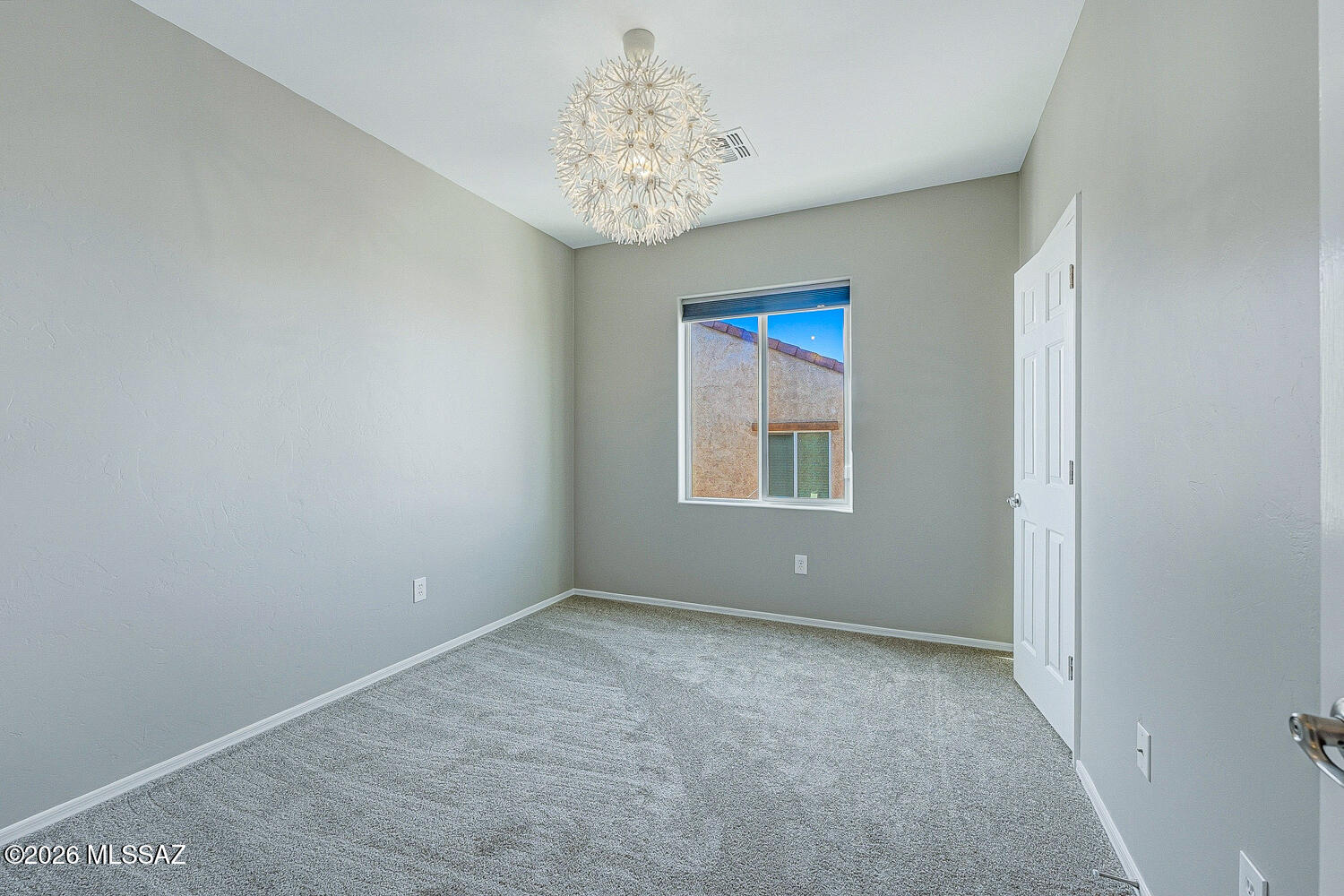 323 East Refuge Loop Vail, AZ 85641 - Photo 32 of 51 an empty room with windows and chandelier fan