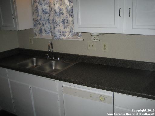3243 Nacogdoches Road, Unit 910 San Antonio, TX 78217 - Photo 3 of 3 a kitchen with a sink and cabinets